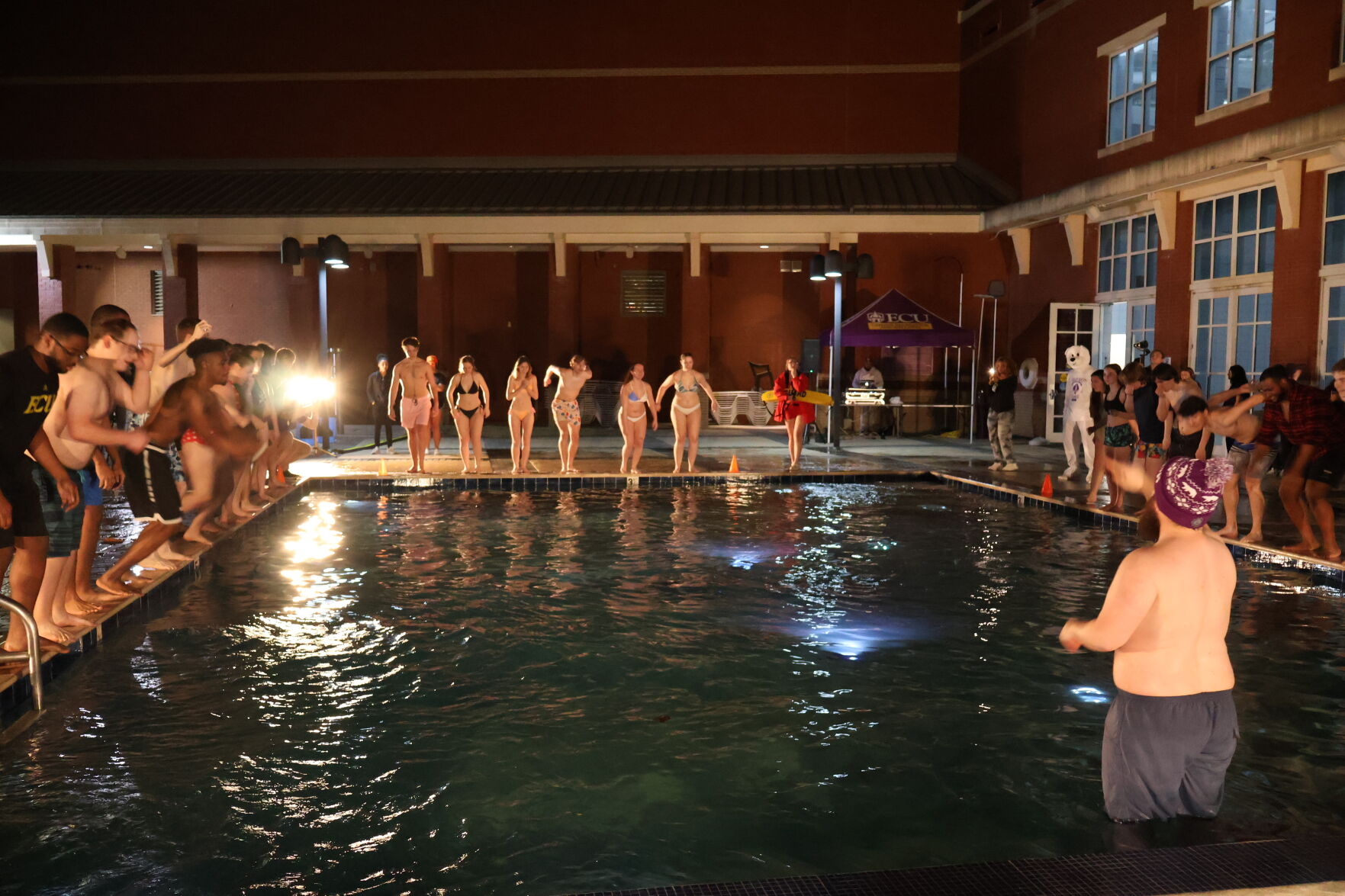 students waiting to jump into the cold water